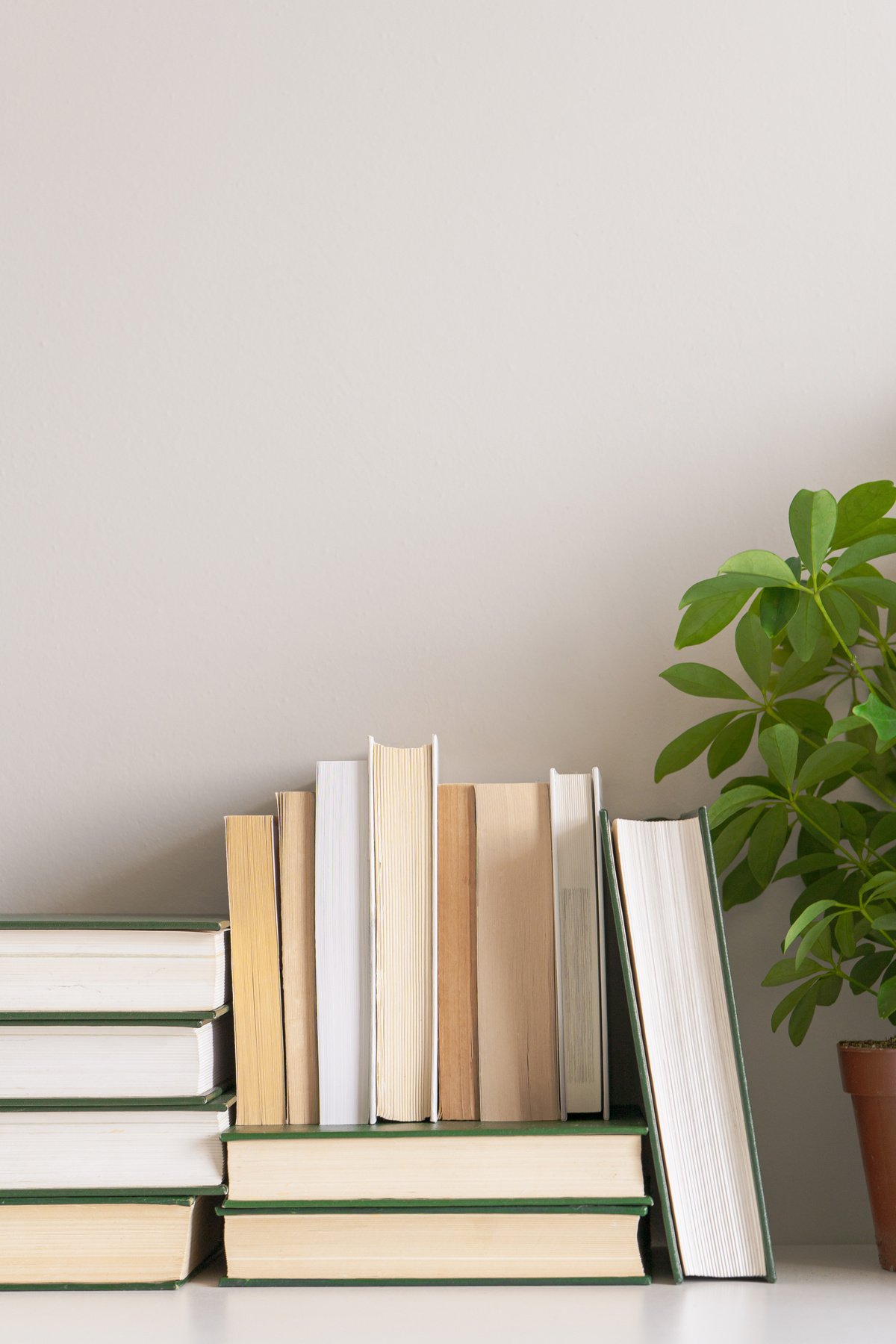 Neutral background with home office desk corner, old books, copy space